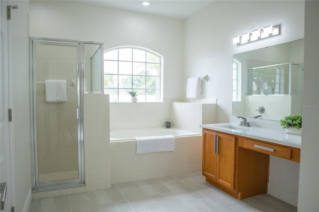 bathroom with tile patterned floors, vanity, and separate shower and tub