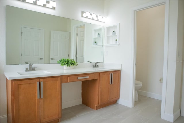 bathroom with tile patterned floors, vanity, and toilet