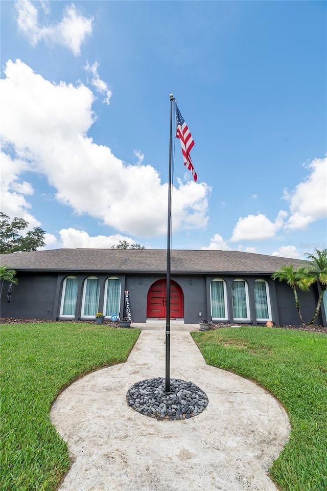 ranch-style home with a front lawn