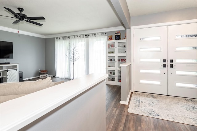 foyer entrance featuring crown molding, dark wood-type flooring, ceiling fan, and french doors