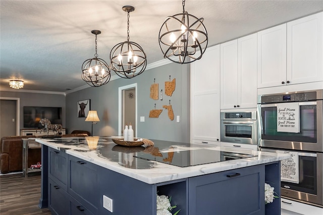 kitchen featuring white cabinetry, double oven, decorative light fixtures, and blue cabinets