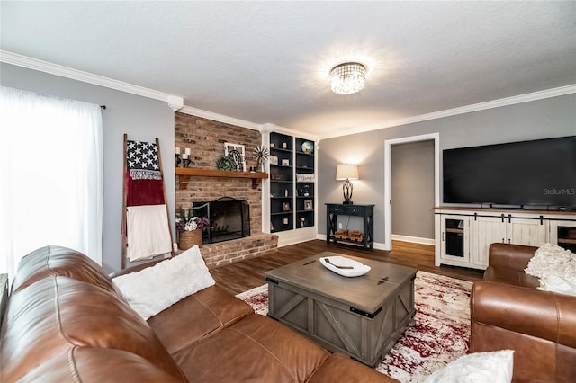 living room featuring ornamental molding, a brick fireplace, dark wood-type flooring, and a textured ceiling