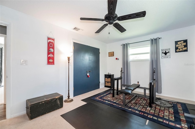 workout room with ceiling fan and carpet floors