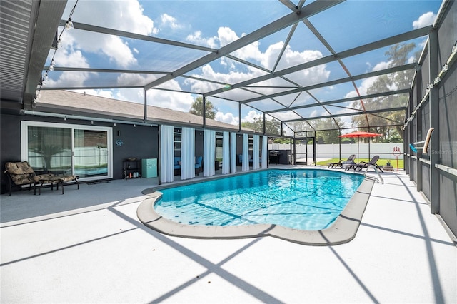 view of swimming pool with a patio and glass enclosure