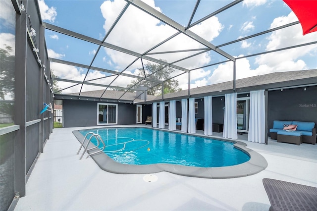 view of pool with an outdoor hangout area, glass enclosure, and a patio area