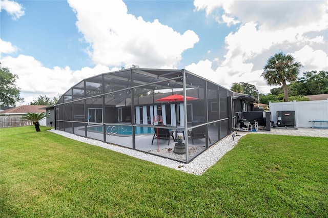 rear view of property featuring a fenced in pool, a patio area, central air condition unit, and a lawn