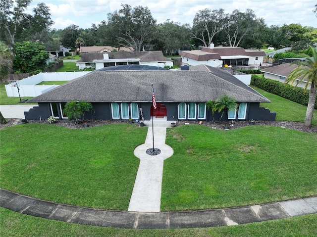 ranch-style home featuring a front yard