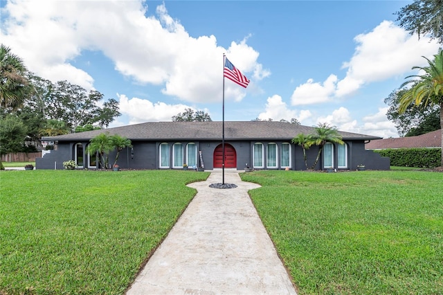 ranch-style house with a front yard and stucco siding