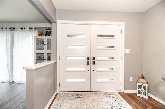 foyer entrance featuring dark wood-style flooring and baseboards