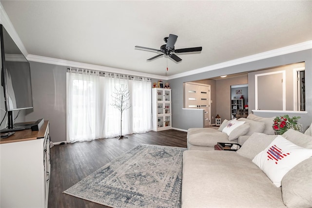 living room with dark wood-style floors, crown molding, and ceiling fan