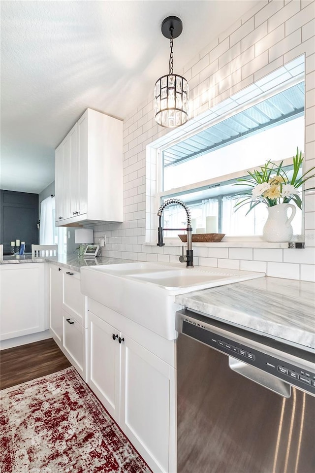 kitchen featuring stainless steel dishwasher, plenty of natural light, decorative backsplash, and white cabinets