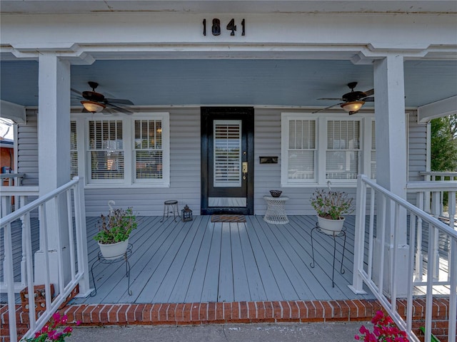 wooden terrace featuring a porch and ceiling fan