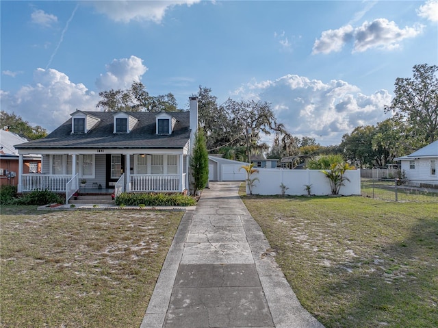 view of front of property with a garage, an outdoor structure, covered porch, and a front lawn