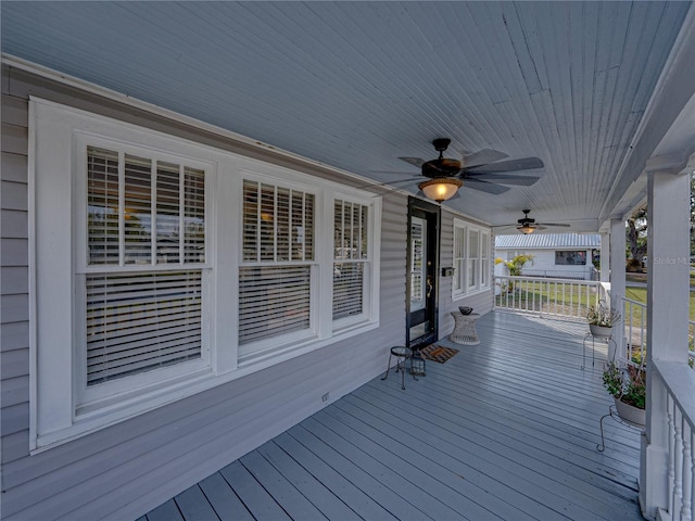 wooden terrace featuring ceiling fan and covered porch