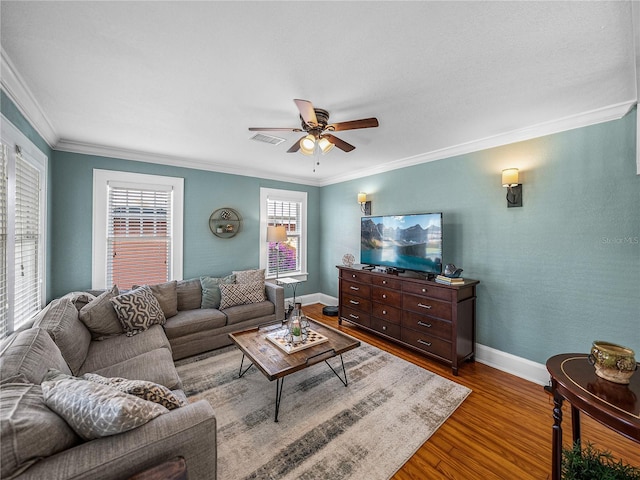 living room featuring ornamental molding, hardwood / wood-style floors, and ceiling fan