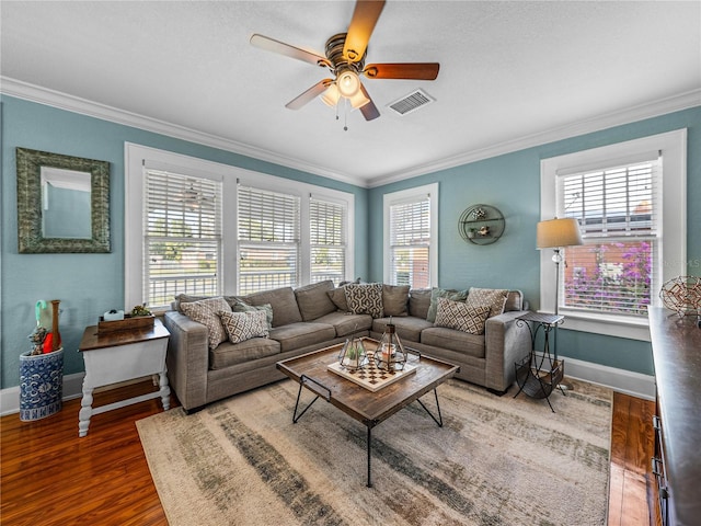 living room featuring dark hardwood / wood-style flooring, ornamental molding, and ceiling fan