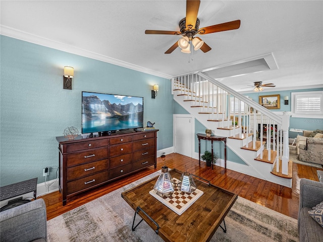 living room featuring hardwood / wood-style flooring, ornamental molding, and ceiling fan