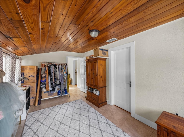 tiled bedroom with wood ceiling and lofted ceiling