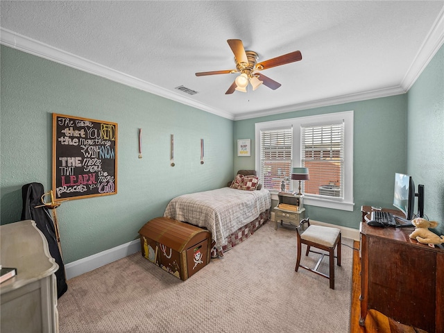 bedroom featuring crown molding, carpet, a textured ceiling, and ceiling fan