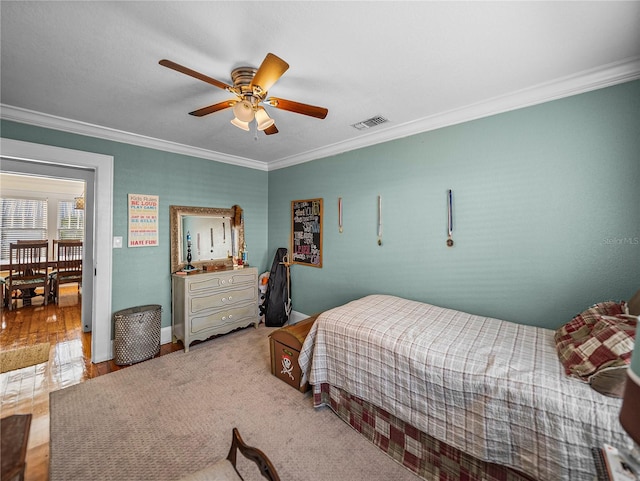 bedroom with ceiling fan and ornamental molding