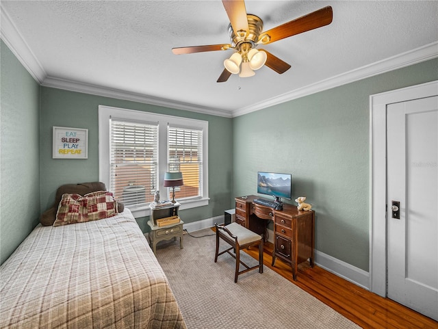 bedroom with ornamental molding, hardwood / wood-style floors, ceiling fan, and a textured ceiling