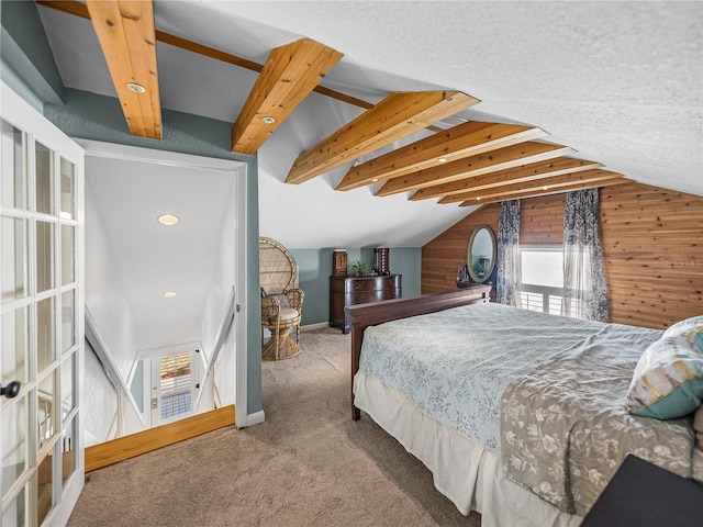 carpeted bedroom with vaulted ceiling with beams and wood walls