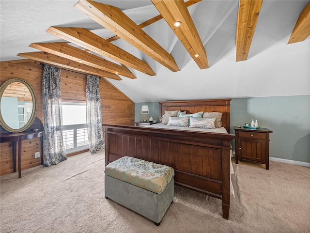 bedroom featuring lofted ceiling with beams, light colored carpet, and wooden walls