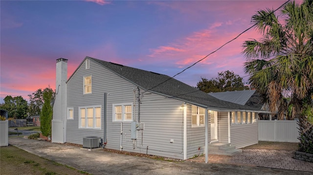 property exterior at dusk with cooling unit