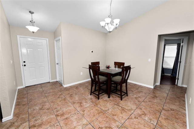 dining space with a notable chandelier and tile patterned floors