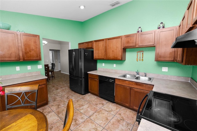 kitchen with light tile patterned floors, sink, and black appliances