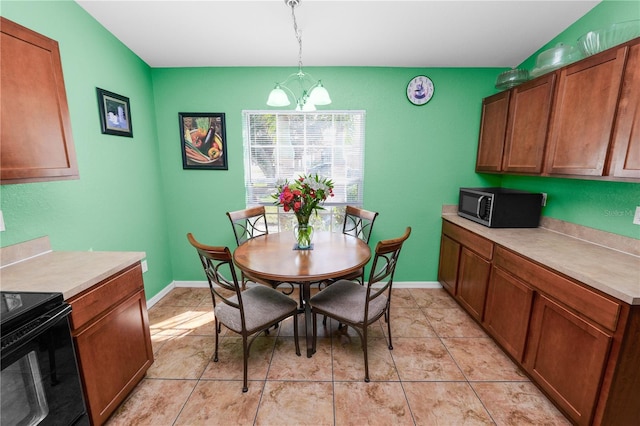 dining space with a notable chandelier and light tile patterned floors