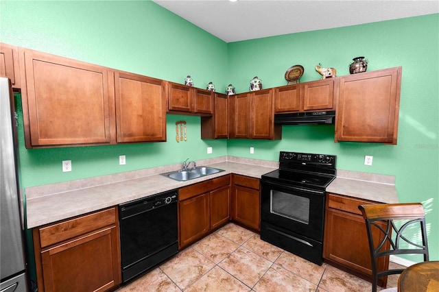 kitchen featuring sink, light tile patterned floors, and black appliances