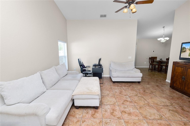 tiled living room with ceiling fan with notable chandelier