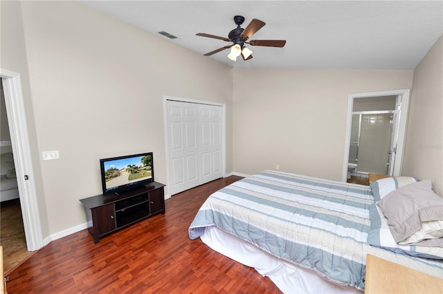 bedroom featuring lofted ceiling, ensuite bath, ceiling fan, dark hardwood / wood-style floors, and a closet