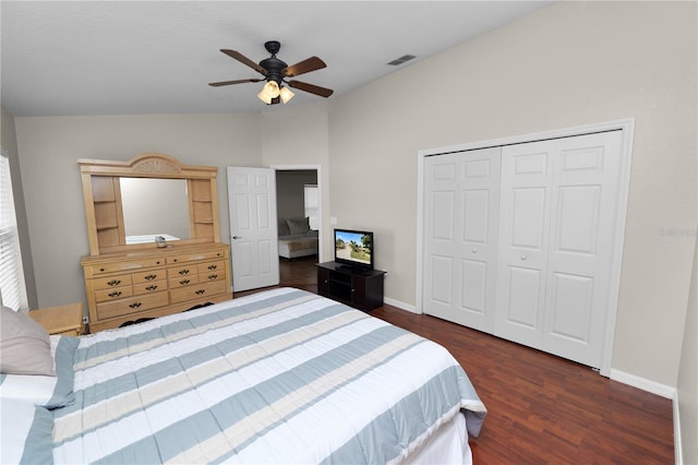 bedroom with lofted ceiling, dark wood-type flooring, ceiling fan, and a closet