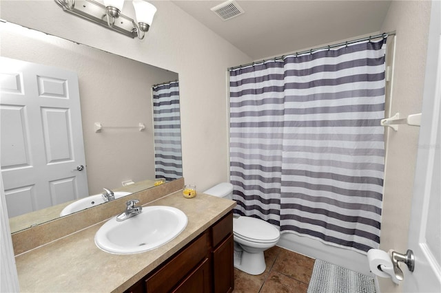 full bathroom with shower / tub combo with curtain, vanity, toilet, and tile patterned flooring