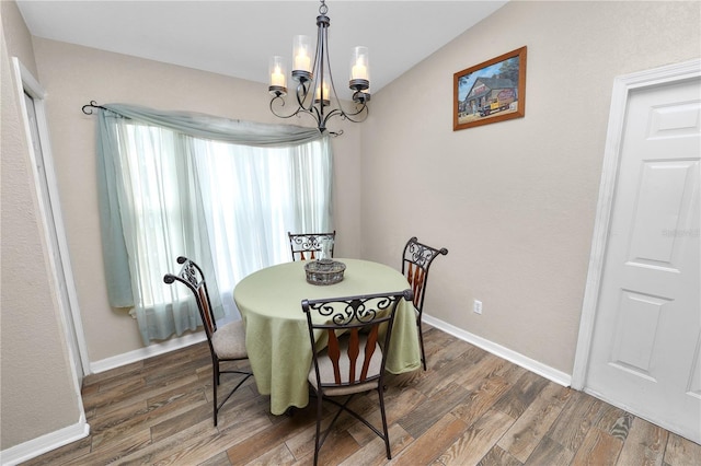 dining area featuring an inviting chandelier and dark hardwood / wood-style floors