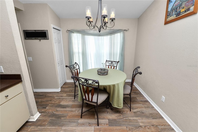 dining room featuring dark hardwood / wood-style floors and an inviting chandelier