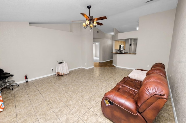 tiled living room with lofted ceiling and ceiling fan