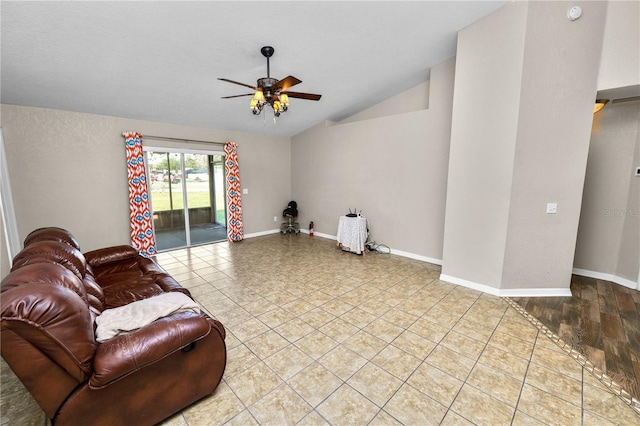 living room featuring ceiling fan, lofted ceiling, and light tile patterned floors