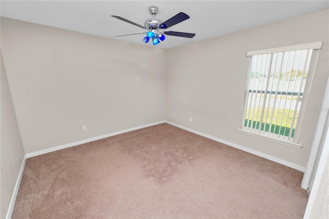 spare room featuring ceiling fan and light colored carpet