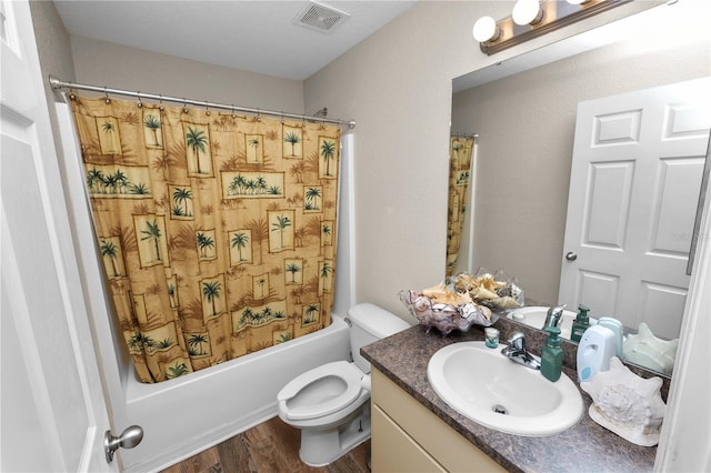 full bathroom featuring shower / tub combo with curtain, vanity, toilet, and hardwood / wood-style floors