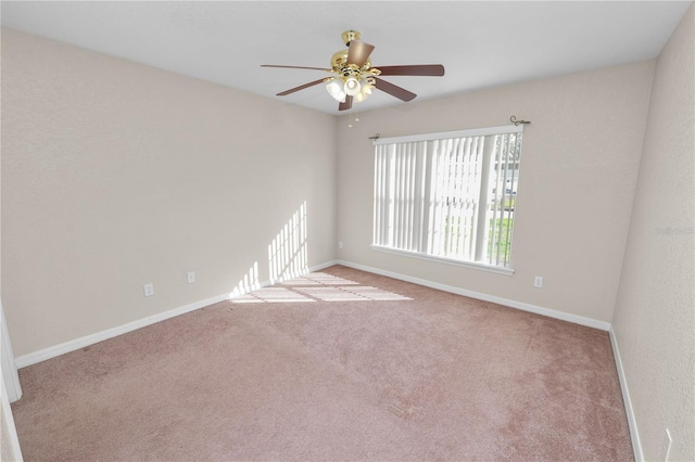 spare room with light colored carpet and ceiling fan