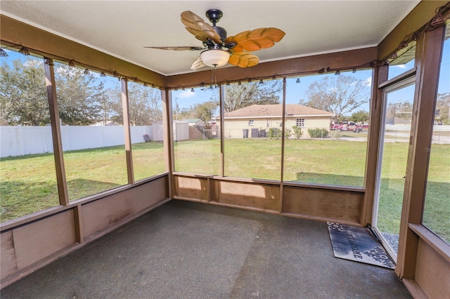 unfurnished sunroom featuring ceiling fan