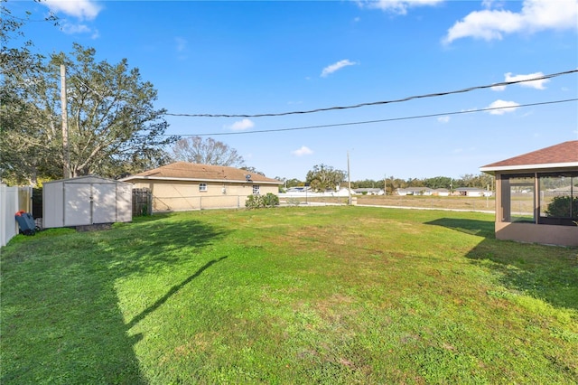 view of yard featuring a storage unit and a sunroom