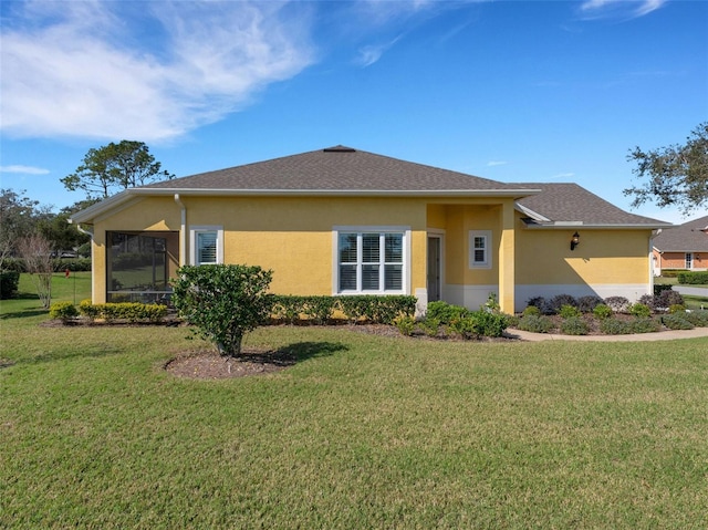 view of property exterior featuring a sunroom and a yard