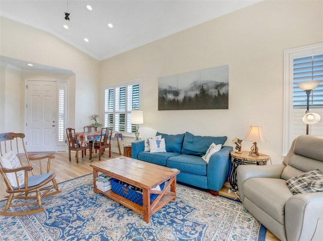 living room with hardwood / wood-style flooring and vaulted ceiling