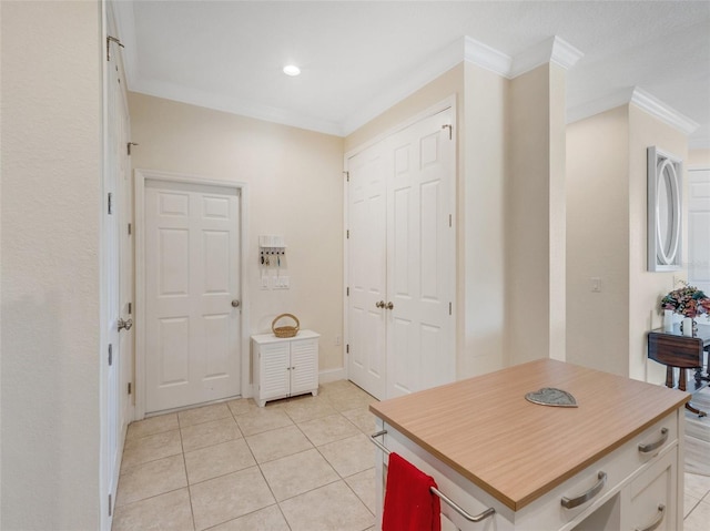 bathroom featuring ornamental molding and tile patterned flooring