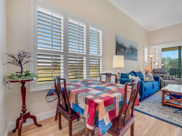 dining room featuring light hardwood / wood-style flooring and ornamental molding