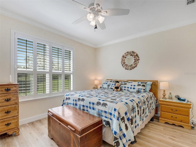 bedroom with crown molding, ceiling fan, and light wood-type flooring